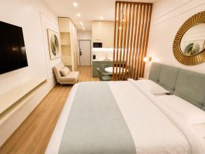 a bedroom with a large bed and a living room at Mar y Sol in Batumi