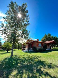 a house with a tree in front of it at Aromas del Mediterraneo Casa de Montaña 2 in Arroyo de Los Patos