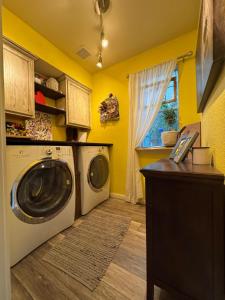 a laundry room with a washing machine and a window at Quaint & Vivacious Room-Queen in Kyle