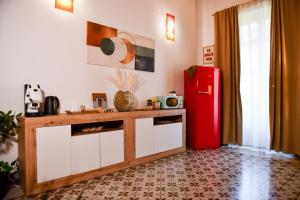 a kitchen with a red refrigerator in a room at La Dimora di Alba in Palermo