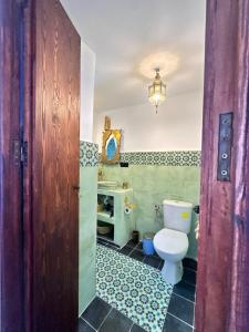 a bathroom with a toilet and a sink at Casa Raselma - Rela Mountains & Spectacular Views in Chefchaouen +55 photos