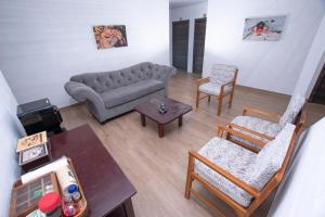 a living room with a couch and chairs and a table at Hospedaje Zerimar Hab 7 in Puerto Baquerizo Moreno