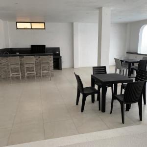 a dining room with tables and chairs and a piano at Hospedaje Zerimar Hab 7 in Puerto Baquerizo Moreno
