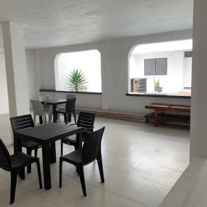 a dining room with tables and chairs and a window at Hospedaje Zerimar Hab 7 in Puerto Baquerizo Moreno +3 photos