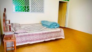 a bedroom with a bed with a blue pillow on it at Murree Sky Heights in Khaira Gali