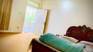 a living room with a couch and a door at Murree Sky Heights in Khaira Gali