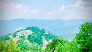 a house on top of a mountain with trees at Murree Sky Heights in Khaira Gali