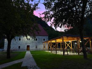 a large building with a pavilion in front of it at Bujtina Shpjia e Gjyshit in Ndërlysaj
