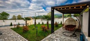 a patio with a chair under a pergola at Rest House İsmayıllı A frame in İsmayıllı