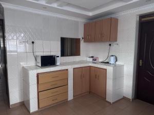a kitchen with a counter top with a microwave at Guyana Guest House in Naivasha