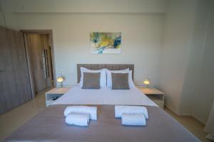 a bedroom with a large bed with two pillows at Gerania nature Residence 21 in Siátista