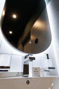 a mirror on top of a counter in a store at Апарт-готель Select in Lviv +70 photos