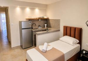 a small room with two beds and a kitchen at Villa Pirofani in Sarti +23 photos