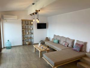 a living room with a couch and a table at Nefeles View in rkadiko Chorio