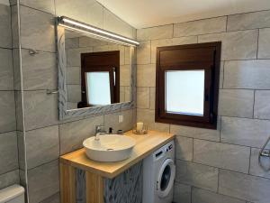 a bathroom with a sink and a washing machine at Nefeles View in rkadiko Chorio +48 photos