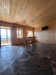 an empty room with two tables and chairs in it at Heshklar guest house in Keshkili