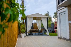 a patio with a gazebo and a table at Türkmen Villa in Belek