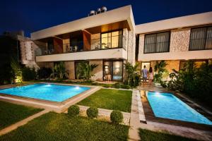 a house with a swimming pool in front of it at Arkk Rooms in Antalya