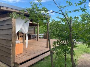 a wooden deck with a table and a tent at Káli Jurta in Tapolca