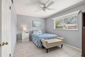 a bedroom with a bed and a ceiling fan at Shark tooth Condo in Venice