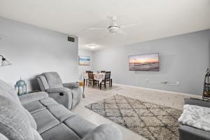 a living room with a couch and chairs and a table at Shark tooth Condo in Venice