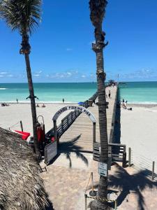 a sandy beach with palm trees and a stairway to the beach at Shark tooth Condo in Venice +14 photos