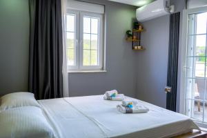 a bedroom with a bed with two towels on it at Türkmen Villa in Belek +36 photos