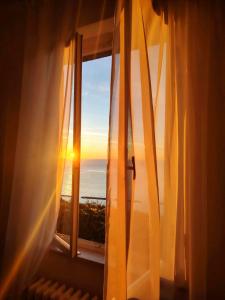a window with a view of the ocean at Castello Di Marà in Cupra Marittima