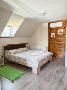 a bedroom with a large bed in a attic at Vila Petar Mokra Gora in Mokra Gora