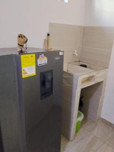 a kitchen with a refrigerator and a sink at Hotel Cascada in Ríohacha +21 photos