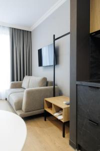 a living room with a couch and a table at Апарт-готель Select in Lviv