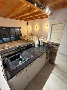 a kitchen with a sink and a counter top at Vikendica BeeLux in Banja Luka