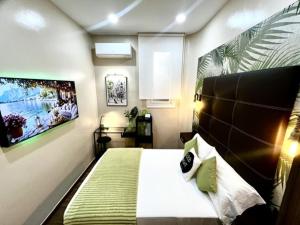 a bedroom with a large bed with a black headboard at Front Arc in Barcelona +40 photos