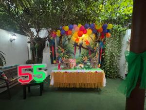 a stage with a table with a sign and balloons at Hotel Luxi in Playa Azul