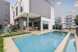 a large swimming pool in front of a building at Zoe Lodge in Midrand