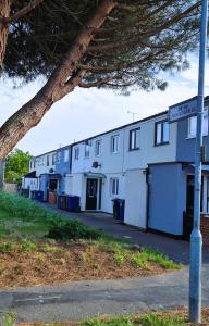 a row of white buildings on the side of a street at Onyx Place Spacious 3BR Home l Fast London Commute l Parking in North Ockendon