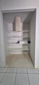 a room with white shelves and a tiled floor at Casa confortável em Tangará in Tangara da Serra