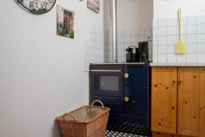a kitchen with a blue stove and a basket at Naturidyll Lavantall in Lading +19 photos