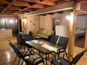 a living room with a table and chairs and a couch at Kućica Pirata in Ulcinj