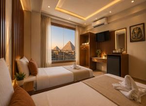 a hotel room with two beds and a view of the pyramids at Lava pyramids hotel in Cairo