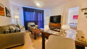 a living room with a couch and a table at Apartamento Oasis Tamarindo Vista Al Mar in Corralejo