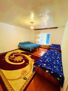 a bedroom with two beds in a room at Sweet home in Lerik