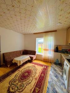 a living room with a couch and a rug at Sweet home in Lerik