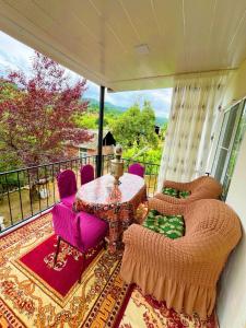 a balcony with a table and chairs and a view at Sweet home in Lerik