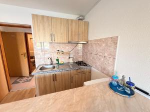 a kitchen with a sink and a counter top at Apartments TORO Pag in Pag +79 photos