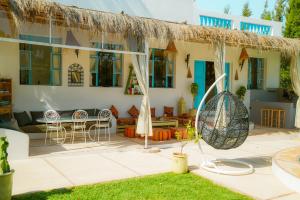a house with a straw roof and a patio at Villa Aloe Vera Privée in Essaouira