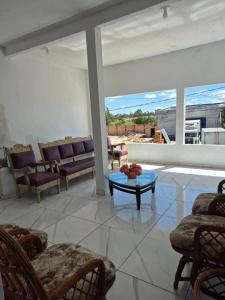 a living room with couches and a table at Manancial de Aguas V in Barreirinhas +11 photos