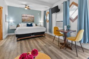 a bedroom with a bed and a table and chairs at Pepperell Place Inn Inc. in St. Peter's