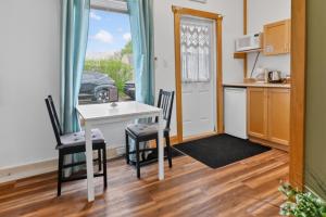 a kitchen and dining room with a table and chairs at Pepperell Place Inn Inc. in St. Peter's +78 photos