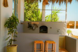 two orange stools in a room with a fireplace at Villa Aloe Vera Privée in Essaouira